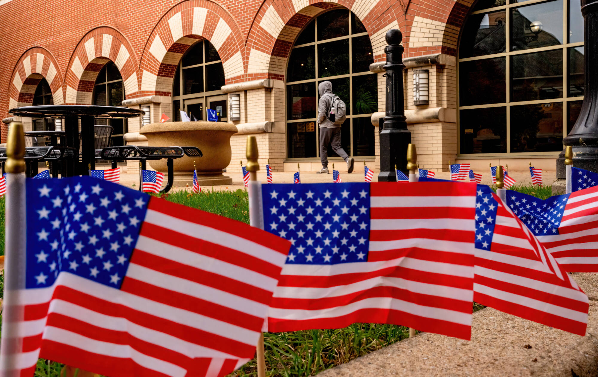 Veteran’s Day flags surround the courtyard on the Richard M. DeVos Center on the Robert C. Pew Grand Rapids Campus. 2025-11-11. Photography by Steve Jessmore